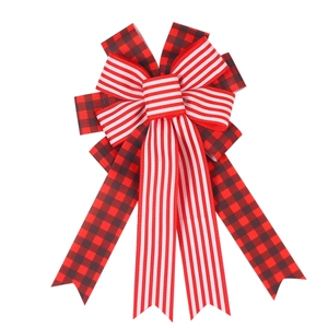 Detail of layered Christmas hair bow with red buffalo plaid and striped ribbons