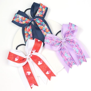 Three-piece set of girls' bow hair ties with colorful heart patterns on ribbon texture
