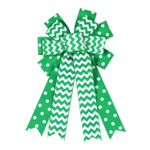 Detailed view of emerald green and white chevron bow hair clip with Santa Claus motif