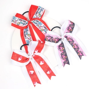 Detail of red and pink bow hair ties with I Love You print and cupcake heart patterns
