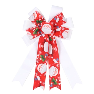 Detail of red and white grosgrain ribbon bow with festive Santa and snowflake prints