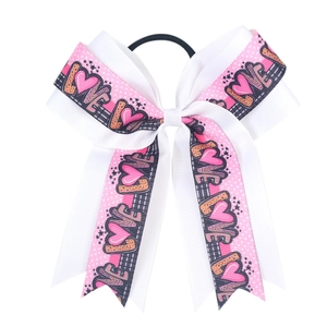 Detail of a large double-layered bow hair tie with LOVE text and pink heart patterns
