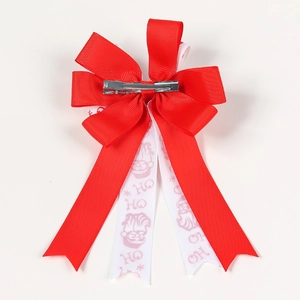 Detail of Christmas bow hair clip with Santa pattern and silver metal alligator clip