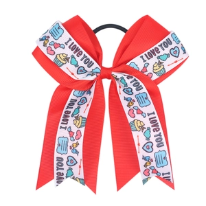 Detail of red Valentine's bow hair tie with I Love You print and colorful heart patterns