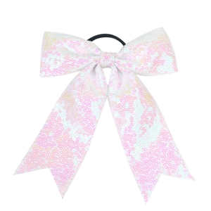 Detailed macro view of sparkling pink and white sequin bow hair tie with elastic band