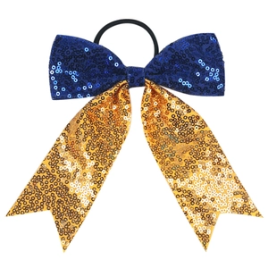 Detailed view of bicolor sequined bow hair tie with blue sequins and long golden tail