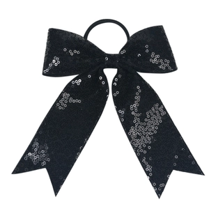 Close-up of black sequined bow hair tie with silver dots and elastic rubber band