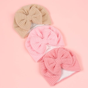 Three-pack of baby bow hats in beige and pink shades with soft textured bubble fleece