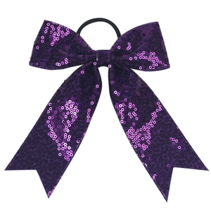 Detailed view of purple sequin bow hair tie with long streamers and elastic band