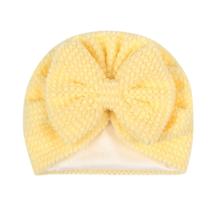 Detail of baby turban with yellow popcorn knit fabric and white satin lining