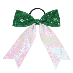Close-up of glittery green and white sequin bow hair tie with long ribbon streamers