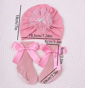 Detailed view of baby pink lace flower headband and matching large bow socks set