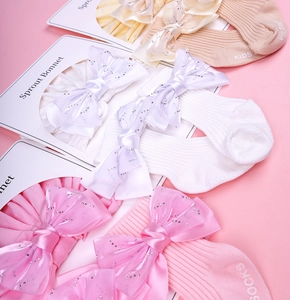 Ensemble bébé bandeau et chaussettes en coton avec nœuds à paillettes et tricot côtelé