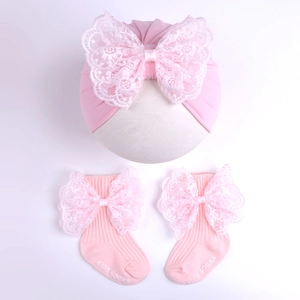 Pink knitted baby hat and socks set with lace bows and non-slip soles for girls