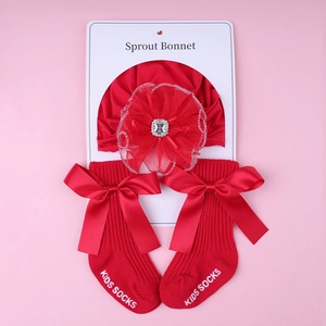 Detail of red lace flower rhinestone baby bonnet and matching bow socks set
