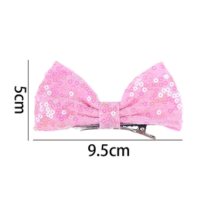 Pink sequin bow hair clip showing 9.5cm width and 5cm height dimensions for girls