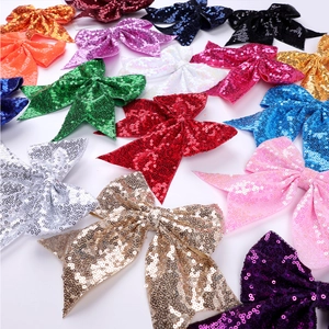 Close-up of glitter sequins and exquisite embroidery on colorful bow hair clips