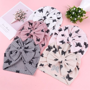 Infant waffle knit beanies with butterfly prints and large bows in five colors