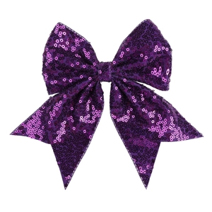 Detail of a purple sequined bow hairclip with reflective sparkles and symmetrical shape