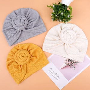 Baby turban hats in gray, yellow, and beige with donut knot detail and soft knit texture