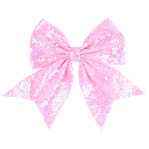 Detail of pink sequin bow hair clip with double ribbons and shimmering texture finish