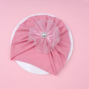 Detail of pink baby turban hat with layered mesh flower, large rhinestone and ribbon bow