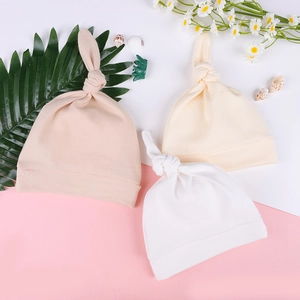 Three-piece set of newborn knotted hats in soft knit cotton for warmth and comfort