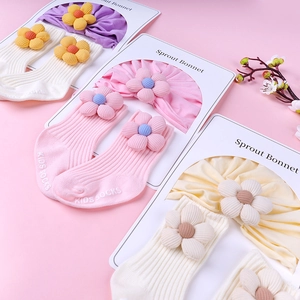 Knitted cotton baby bonnet and socks set with 3D fabric flower decor in pastel colors