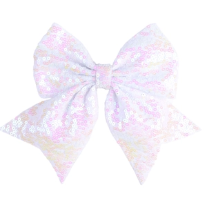 Detail of white swallowtail bow hair clip with shimmering sequins and wavy texture