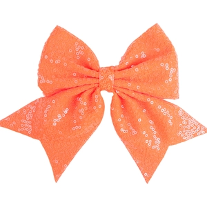 Macro detail of large orange sequin bow hair clip with sparkling embroidered texture
