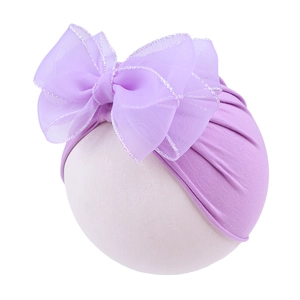 Detail of baby girl hat with purple oversized double lace bow and organza edges