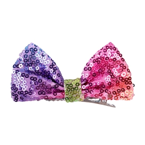 Detail of a 4 inch sequin bow hair clip with multi-color gradient and metal alligator base