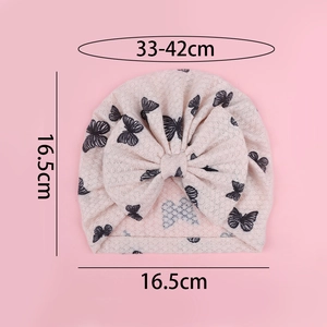 Detail of pink baby turban hat with black butterfly print and large bow embellishment
