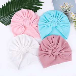 Infant turban hats in four soft colors featuring ribbed knit fabric and cross knot design
