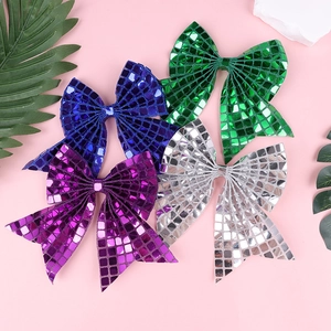 Close-up of glitter sequins bow hairclips in vibrant purple, blue, green and silver
