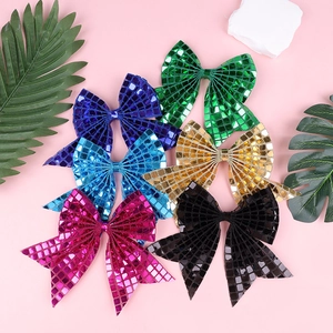 Close-up of colorful sequin bow hair clips with shiny grid texture for girls