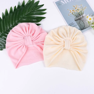 Soft cotton baby turban hats in pink and beige colors with a stylish knot design