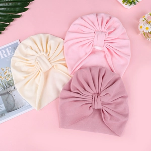 Detailed view of soft cotton baby turbans in off-white, light pink and dusty rose colors