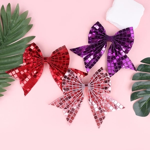 Detail of sequined bow hair clips with shiny grid patterns for festive party decorations