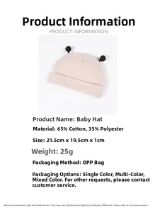 Détail du bonnet rose pour bébé avec pompons noirs montrant le tissu et les dimensions