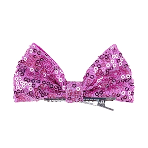 Detail of 4-inch pink sequin bow hair clip with silver metal alligator attachment