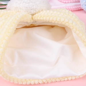 Close-up of yellow baby winter hat showing warm corn velvet texture and soft inner lining