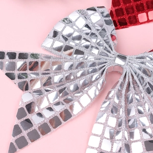 Macro shot of silver disco mirror sequin texture on a bow hair clip for girls
