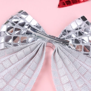 Detail view of the silver disco mirror sequin bow with a secure metal alligator hair clip