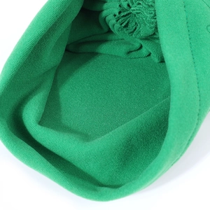 Close-up of soft green knitted texture and stitching details on this warm baby winter hat