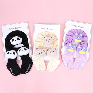 Detailed view of baby cotton ribbed beanie and socks set with 3D plush animal designs
