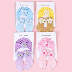Détail de turbans en coton pour bébé et chaussettes assorties avec fleurs en 3D