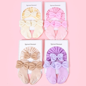 Detail showing baby cotton headband and sock sets with textured bows in four pastel colors