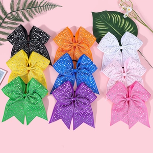 Detail of colorful cheerleader bow hair ties with sparkling rhinestones and elastic bands