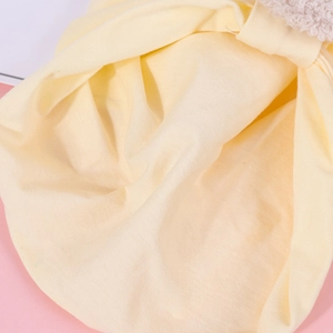Detailed macro shot of soft yellow cotton fabric and sherpa lining for infant gear